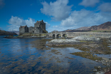 Scottish Castle, Kilchurn Castle, Loch Awe near Oban in the Scottish Highlands. Historic castle reflected in the loch with mountain backdrop. Dramatic lighting on the castle and mountains