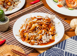 Garlic pork noodles with chopsticks served in dish isolated on table side view taiwanese food
