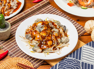 Fresh oysters noodles with garlic paste with chopsticks served in dish isolated on table side view taiwanese food