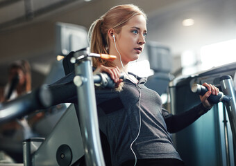 Gym, woman and concentrate on chest press machine for workout to exercise on health, fitness and...