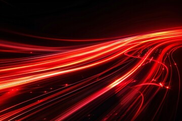 Fototapeta premium Abstract red light trails on a dark background, creating a sense of motion and energy.