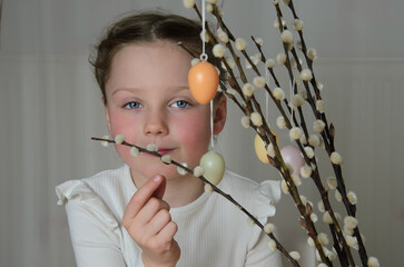 Willow branches with Easter eggs and a girl.