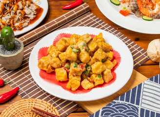 Golden Sand Tofu with spring onion, red pepper and chopsticks served in dish isolated on table side view taiwanese food