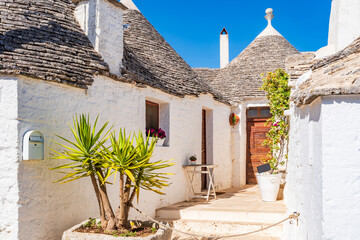 Famous historic dry stone trulli houses with conical roofs in Alberobello, Italy.