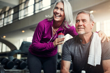 Happy, fitness and mature couple at a gym for water, break or bonding after morning, cardio or...