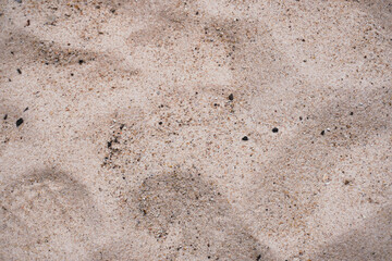 This is a close up picture of sand, creating an interesting texture that can be used for backgrounds or other graphic designs.