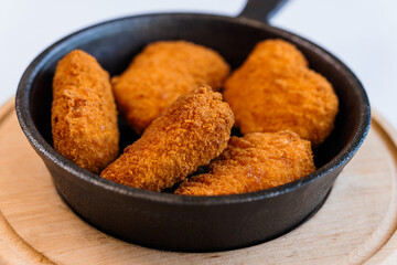 Chicken nuggets in batter on a plate