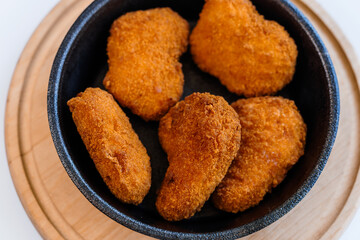 Chicken nuggets in batter on a plate