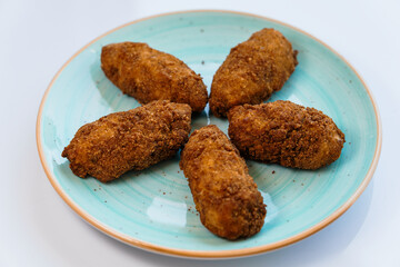Chicken nuggets in batter on a plate