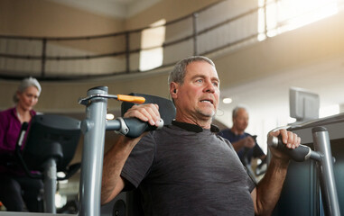 Fitness, chest press and mature man at gym for wellness, training and morning cardio, exercise or...