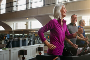 Exercise, treadmill and senior people running in gym for workout, physical health and wellness in...