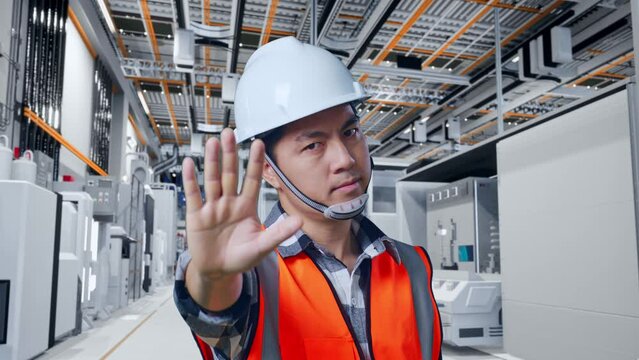 Close Up Of Asian Male Engineer With Safety Helmet Disapproving With No Hand Sign While Standing At Factory Digitalization