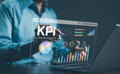 Analyzing Key Performance Indicators. Businessman using digital screen to analyze key performance indicators (KPI) with various graphs and charts, showcasing data analysis and performance tracking.