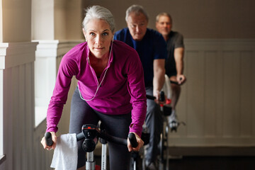 Spin class, fitness or senior woman on bike in workout or training for cycling progress, health or...