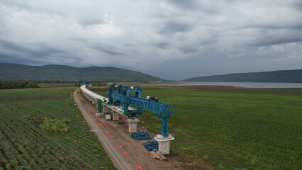 Aerial view of the construction of a new  Infrastructure of the bridge construction site of train transportation. highway construction bridge is under construction. building a bridge over a railroad