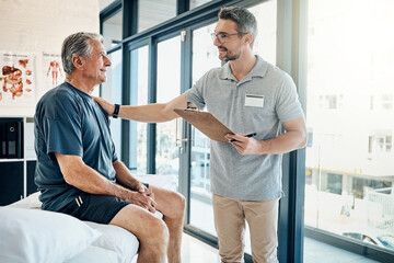 Obraz premium Physical therapy, clipboard and mature man consulting chiropractor at clinic for body, assessment and examination. Physiotherapy, service and client with expert for insurance, checklist or compliance