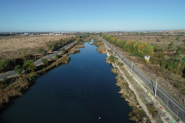 Naklejka premium Aerial picture over Dambovita river nearby Bucharest city in a beautiful morning in autumn season. 
