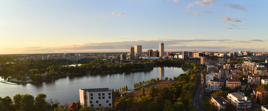 Sunset  panorama over the north part of Bucharest Romania in the new area with tall office buildings and Herastrau lake.