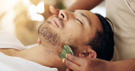 Facial, beauty and man with gua sha treatment for massage, spa aesthetic and skincare benefits for circulation. Guy, dermatology and therapist hand with stone tool for wellness and lymphatic drainage