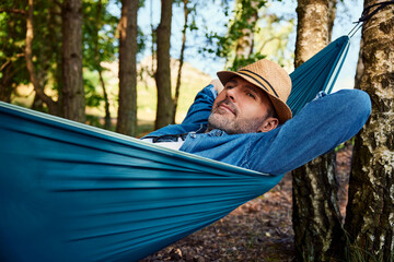 Carefree man lying in hammock