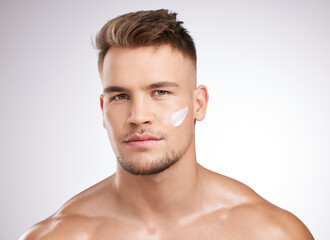 Obraz premium Skincare, portrait and man in studio with cream for moisturizer, grooming or morning routine on white background. Body, wellness and model with confidence for lotion, cosmetics or satisfaction