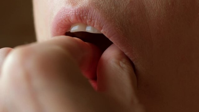 Close-up mouth of person taking a fish oil capsule and drinking a glass of water. omega 3 6 9 dietary supplements. Taking pill and vitamin. Healthy lifestyle. Macro shot. biologically active additive