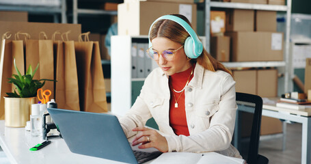 Woman, laptop and small business with headphones, reading and logistics for thinking, sales report...