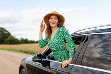 Woman tourist on road, enjoying window view and traveling on holiday road trip. Travel adventure drive.