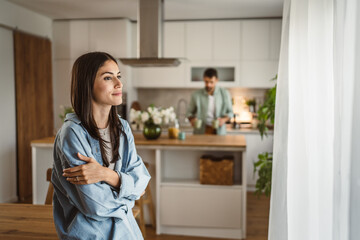 girlfriend wait for coffee while boyfriend prepare in the kitchen