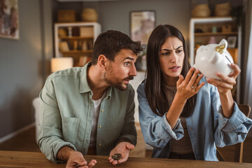 Happy boyfriend and girlfriend save money together in the piggy bank