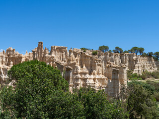 Fototapeta premium Orgues of Ille sur tet, sand colored basalt column rock formation in Ille-sur-têt near Perpignan, Roussillon, Pyrenees Orientales, France, copy space