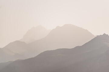 Panorama of a mountain range in the morning at dawn, tonal perspective of mountains in the morning...