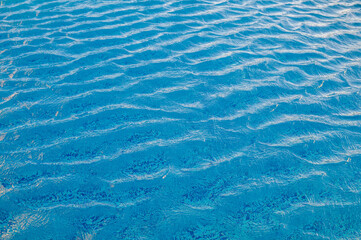 Swimming Pool Surface With Light Reflection and Water Ripple Patterns