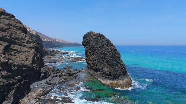 Aerial clip of the incredible rock formation of Roque del Moro near Playa de Cofete in Fuerteventura Canary Islands Spain