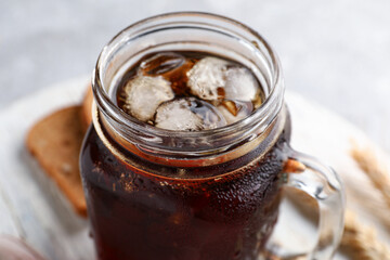 Mason jar of tasty kvass on grey background
