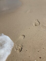 footprints on the beach in the sand