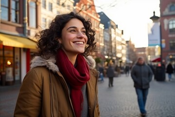 Fototapeta premium Portrait of a beautiful young woman with curly hair in the city