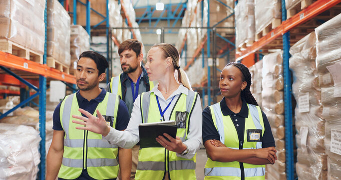 Woman, tablet and group with walking in warehouse with shelf, package or stock check with diversity. People, men and team with discussion for logistics, inventory or cargo for supply chain at factory