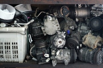 A lot of an old compressors on the shelf, car air conditioning system.