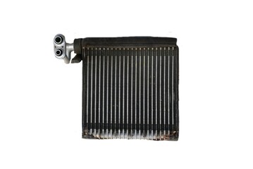 An old rusty evaportor coil of an air car compressor on background.