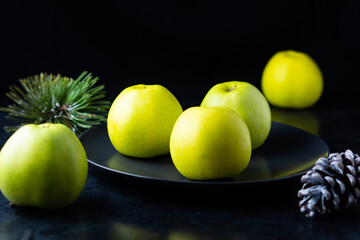 Fresh ripe green apples on wooden table against dark background, space for text