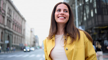 Woman smiling and enjoying her walk in the city