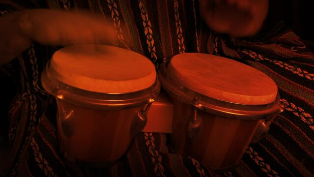 Man Plays Bongos In Firelight