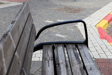 A bench for relaxing in a city park on the seashore.