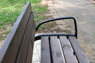 A bench for relaxing in a city park on the seashore.