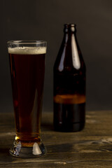 dark beer in a glass glass, fresh dark alcoholic beer