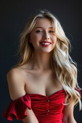 Naklejka premium A woman poses for a photo wearing a bright red dress, offering a confident and sassy expression