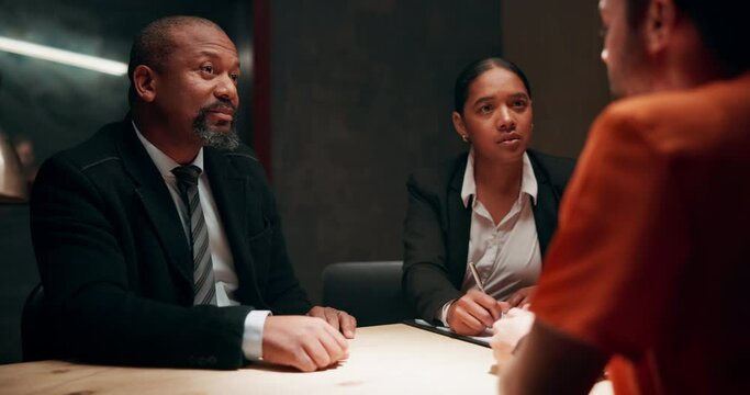 Lawyer, conversation and criminal client in interrogation room for investigation, information or arrest. Advocate, diversity and people with suspect for justice, interview or planning alibi for case