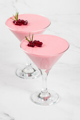 Pomegranate cream jelly dessert, Panna Cotta in martini glass. White background