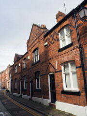 street of old traditional red brick victorian houses on a road in Chester England